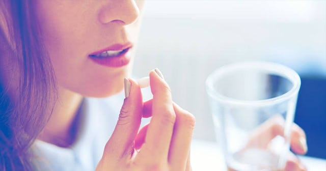 A woman taking her meds