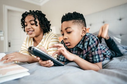 Why I'm Choosing Remote Learning For My Kids This Fall: Kids with tv remote control
