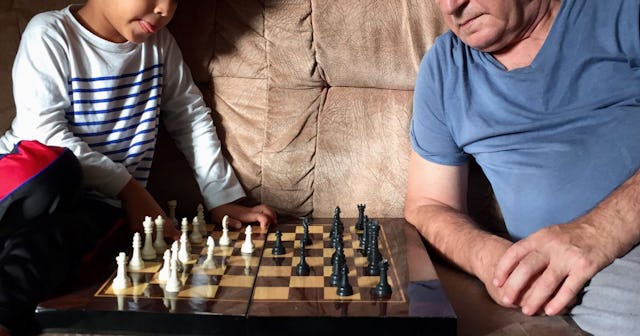When Grandparents Say You're 'Using Your Child As A Pawn': child and grandfather playing chess