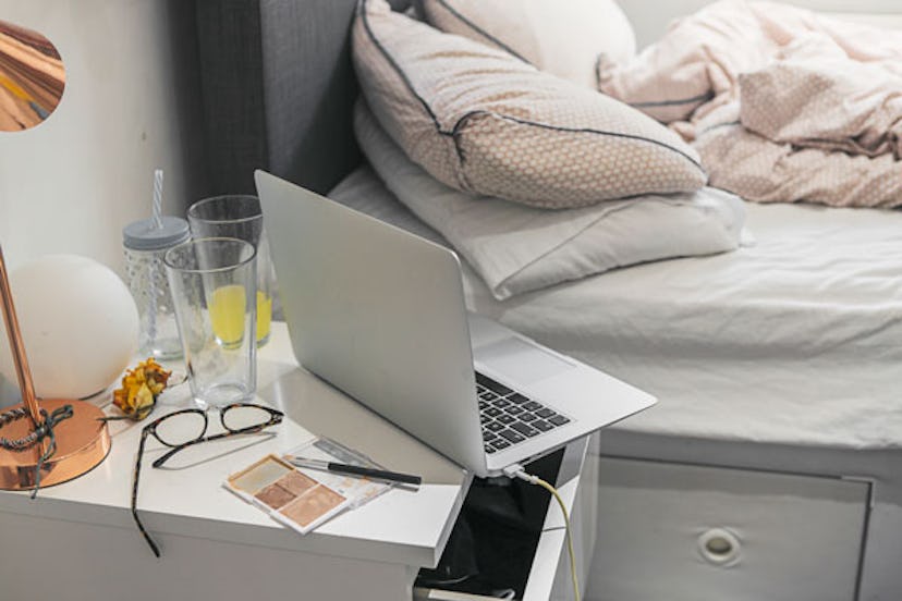 crowded nightstand in bedroom