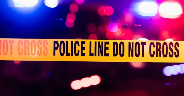 Accident or crime scene cordon tape, police line do not cross. It is nighttime, emergency lights of ...