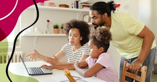 Parents Helping Their Daughter With Homework while using Laptop in the Kitchen at Home