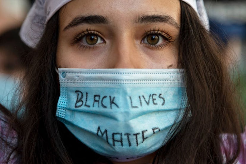demonstrator wears a protective mask reading 'Black Lives Matter' during Black Lives Matter protest ...