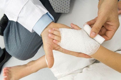 Doctor wrapping a patient's hand in gauze