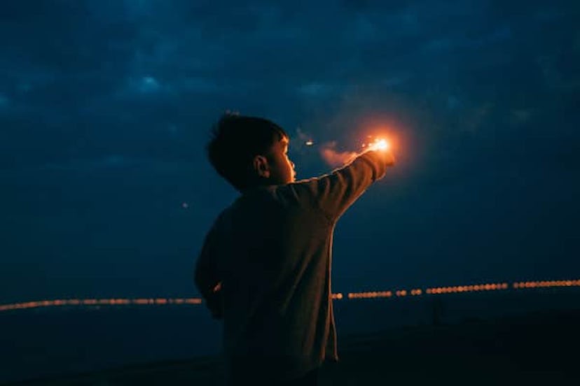 a boy playing with Fireworks