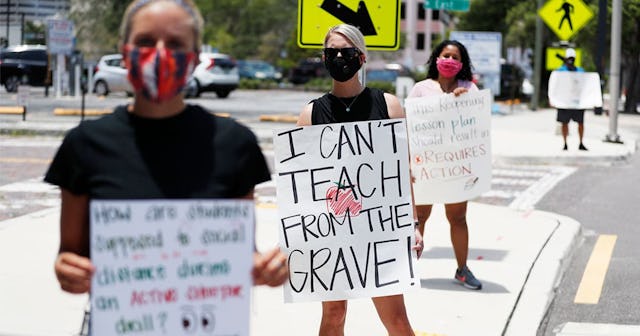 Middle school teacher Brittany Myers, (C) stands in protest in front of the Hillsborough County Scho...