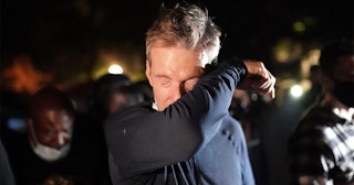 ortland Mayor Ted Wheeler reacts after being exposed to tear gas fired by federal officers while att...