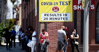 People stand in line at a clinic offering quick coronavirus testing for a fee in Wilmington on Monda...