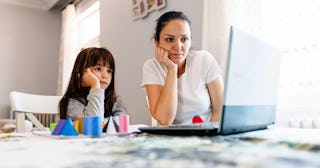 mother helps her daughter in distance education classes