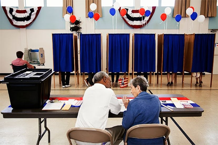 Workers sitting at registration desk in polling place