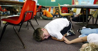 Kindergarten students lie on the floor during a classroom lockdown drill February 18, 2003 in Oahu, ...