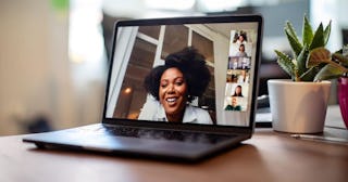 Businesswoman having a video call meeting with her team