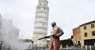A worker carries out sanitation operations for the Coronavirus emergency in Piazza dei Miracoli near...