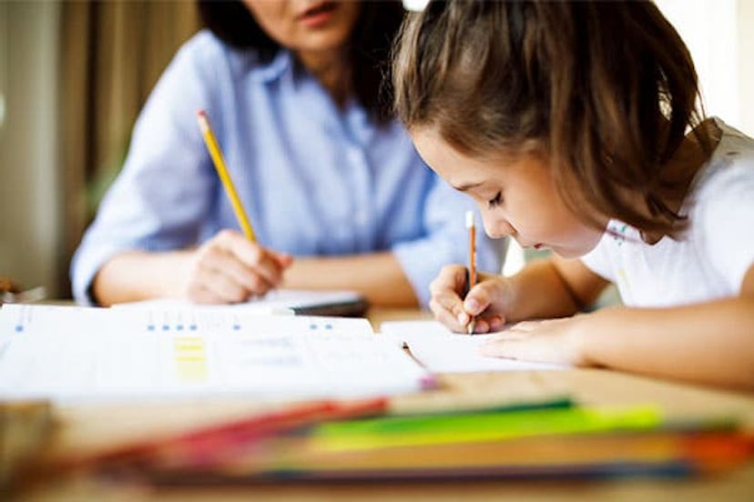 Mother helping daughter with homework