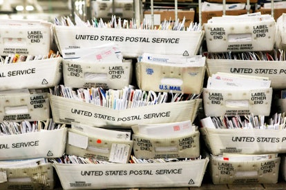 Why We Absolutely Must Save The USPS: Stacks of boxes holding cards and letters are seen at the U.S....