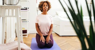 woman practicing yoga at home