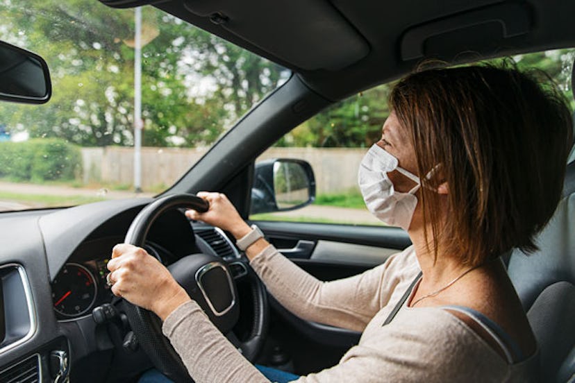 Woman with mask driving car
