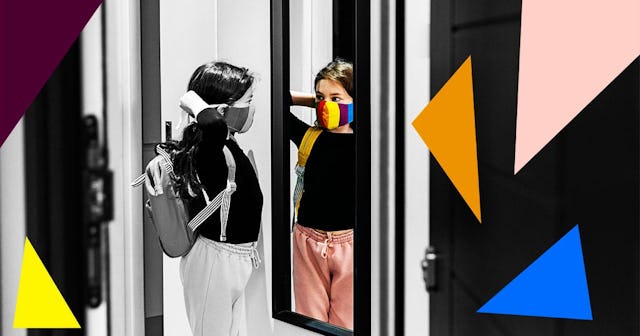 Young girl putting on her face mask in mirror by front door