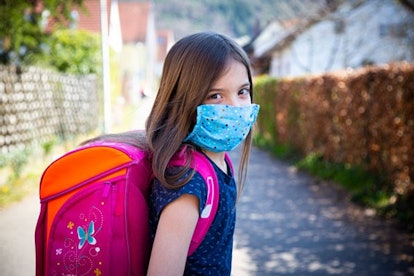 Girl with homemade protective mask on her way to school