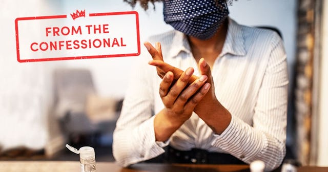 Businesswoman sitting at her desk cleaning hands with sanitizer