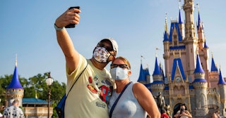 In this handout photo provided by Walt Disney World Resort, guests stop to take a selfie at Magic Ki...