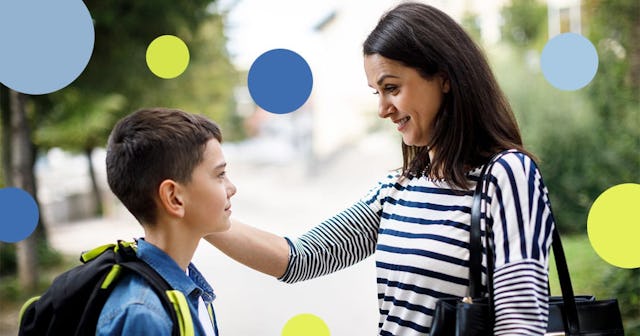 Mother saying goodbye to son in front of school