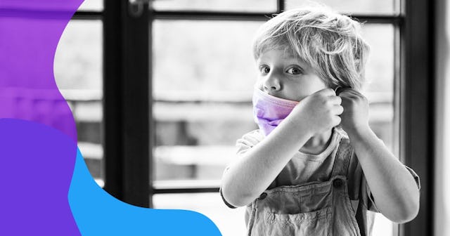 Front view of unhappy small boy with face mask at home