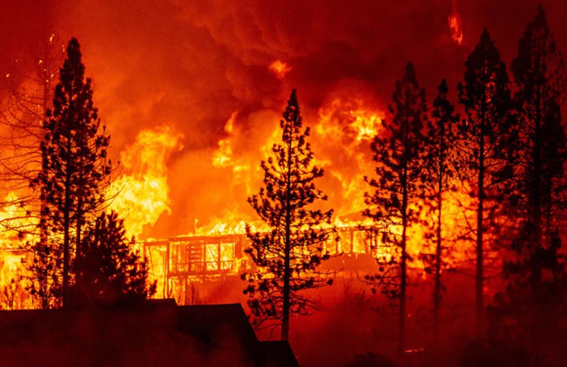 A home is engulfed in flames during the "Creek Fire" in the Tollhouse area of unincorporated Fresno ...