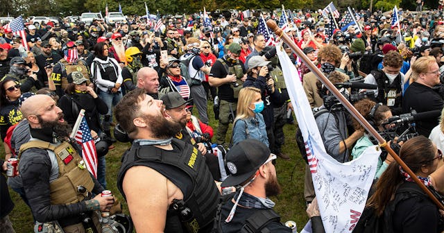 Supporters of President Trump along with Proud Boys listen to speeches during an event on September ...