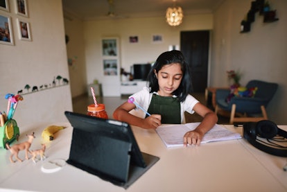 Young girl attending online school