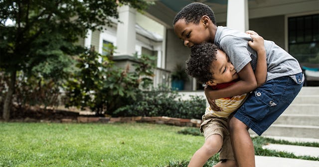 Two boys \ playing in front of house