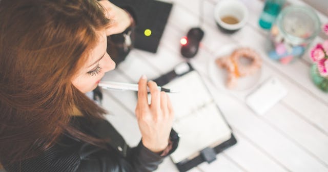 type a personality, Woman chewing on pen over day planner