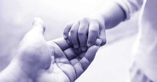 Newborn's hand holding an adult hand by the finger