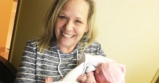 Candace Smith smiling while holding her granddaughter