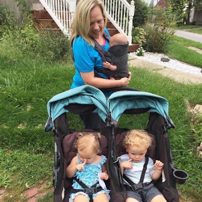 Candace Smith with her two grandchildren in stroller and one on her chest. 