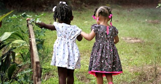 cooperative play, Two young girls walking hand-in-hand