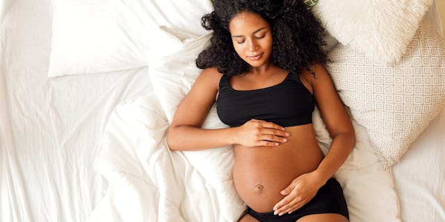 calcified placenta, Pregant Woman Cradling Belly | Calcified Placenta