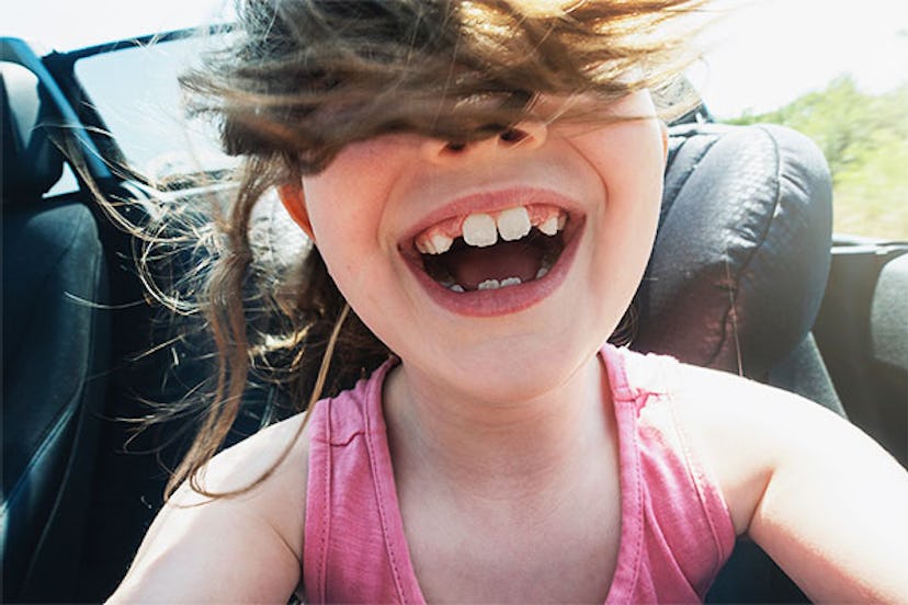 Closeup little girl enjoying her time in a car ride