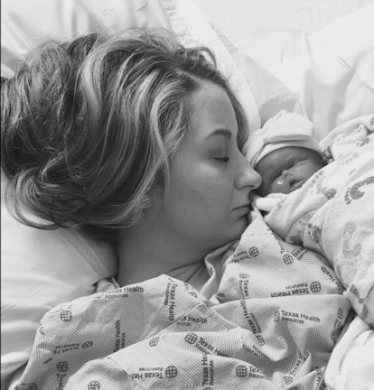 A sleeping woman with her newborn child on her chest in black and white
