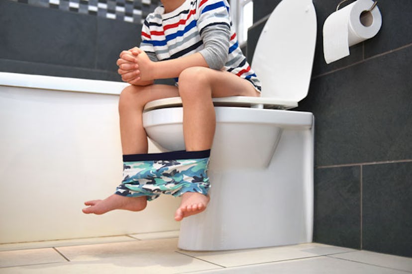 Little child sitting on the toilet