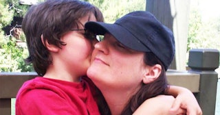 Ilisa Aaron Parish in a black cap being hugged by her son in a red T-shirt