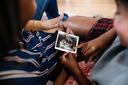 Two women looking at an ultrasound photo together