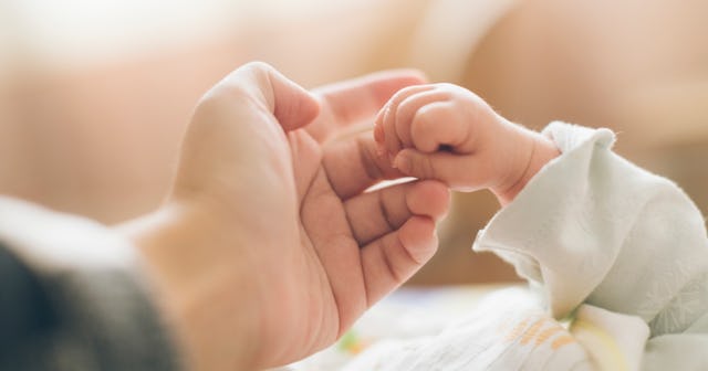 wiccan names, woman holding baby's hand