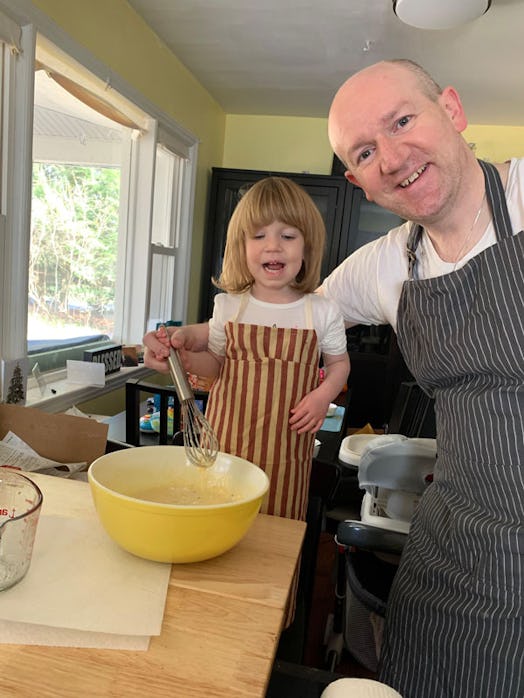 Pamela Addison's late husband Martin cooking with their child while wearing aprons