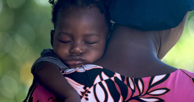 baby sleeping on mother's shoulder