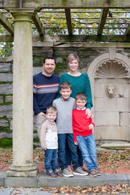 Megan Gill Carusona, who is fighting cancer with her husband and three sons standing outside and pos...