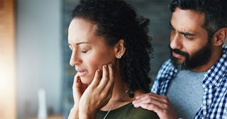 A sad lady being comforted by her husband because of not having orgasms due to antidepressant consum...