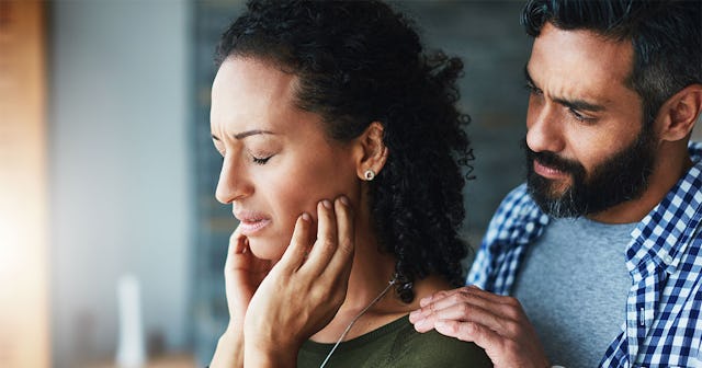 A sad lady being comforted by her husband because of not having orgasms due to antidepressant consum...
