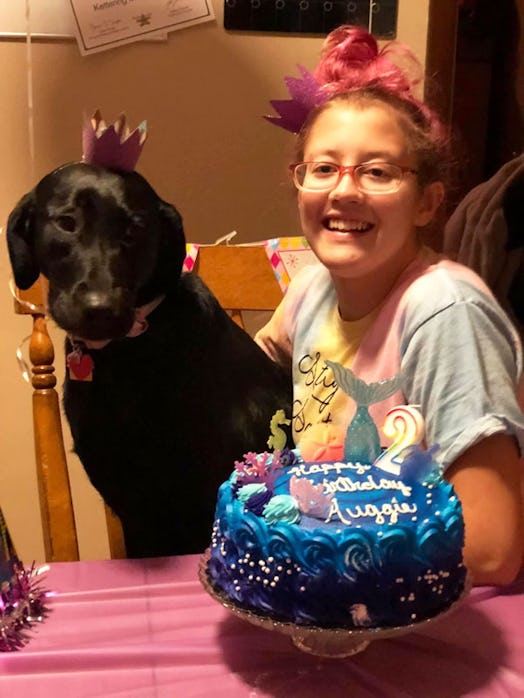 A girl who has a chronic illness celebrating her birthday with a cake in front of her while a servic...