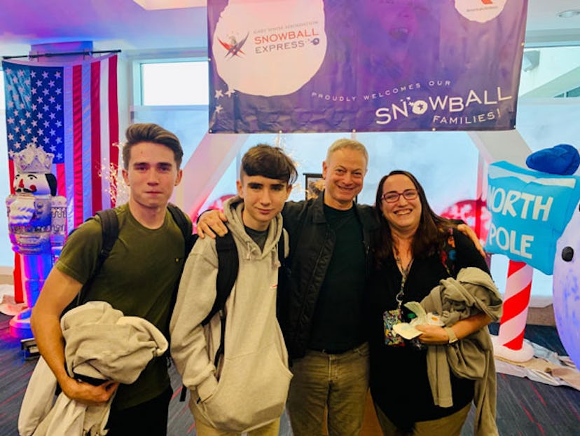 Gary Sinise posing with two young men and a woman at a charity event